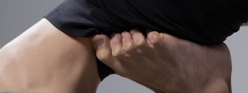 Dynamic yoga posture showing muscle engagement and strength.